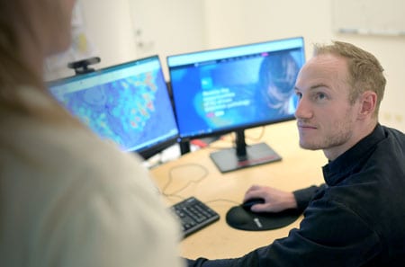 Person at computer looking up